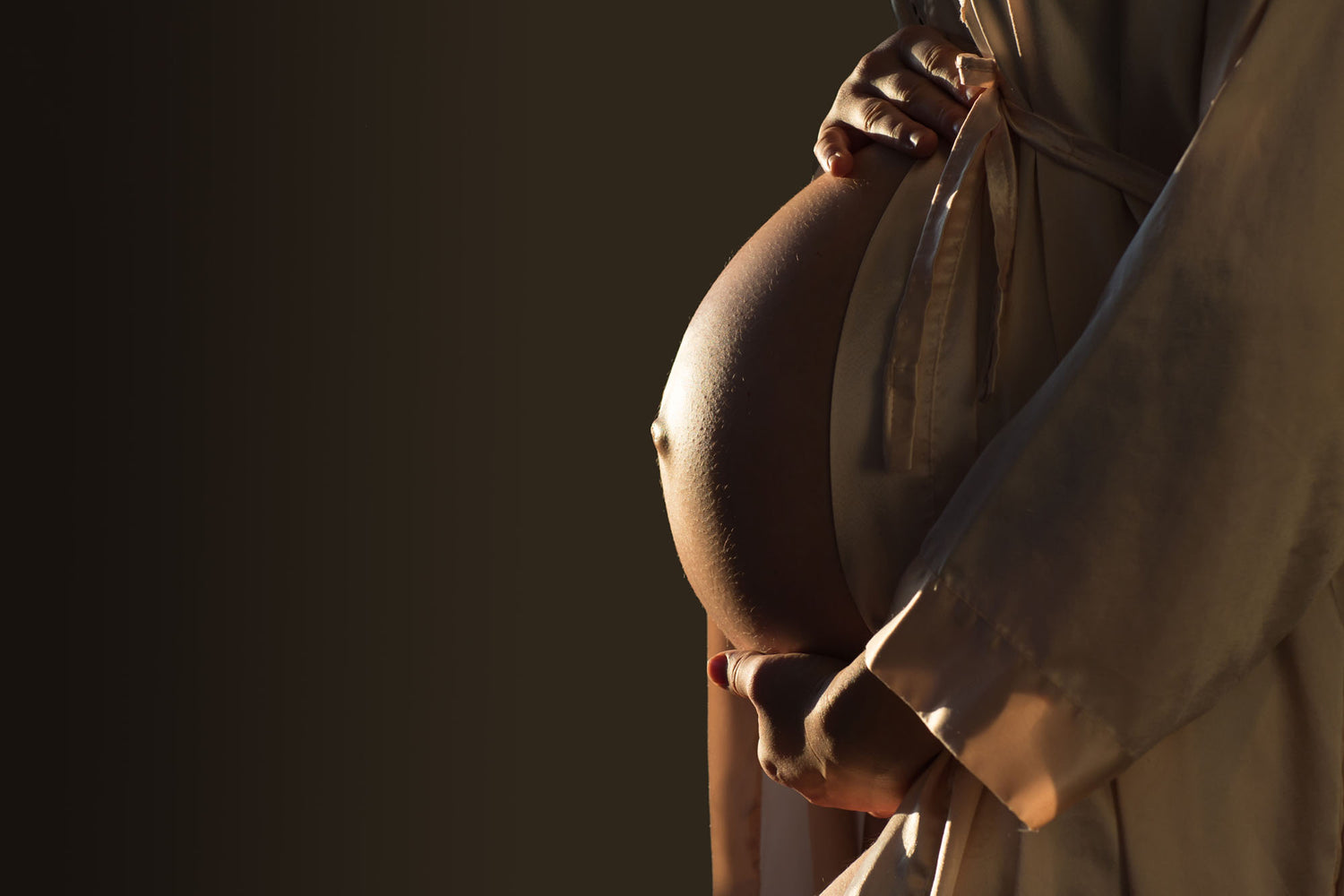 A pregnant woman holding her belly