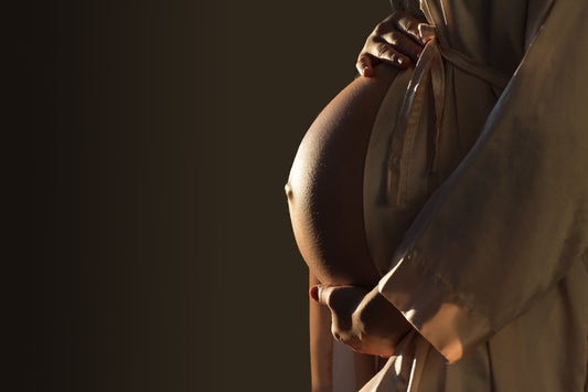 A pregnant woman holding her belly